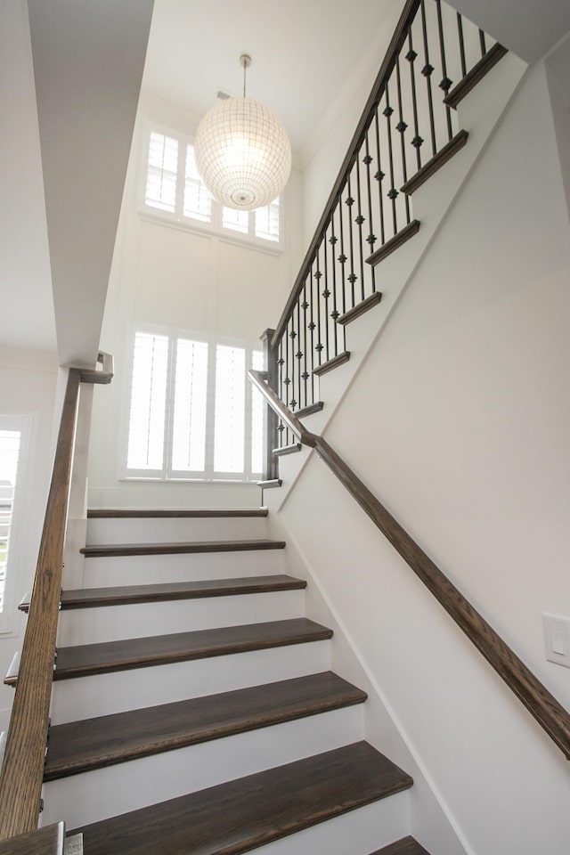 staircase with a towering ceiling