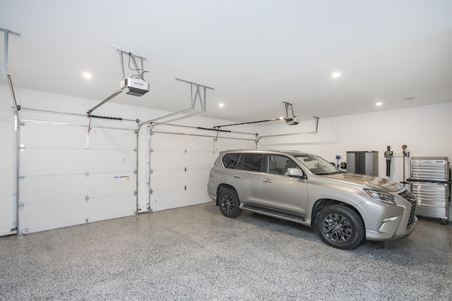 garage featuring recessed lighting and a garage door opener