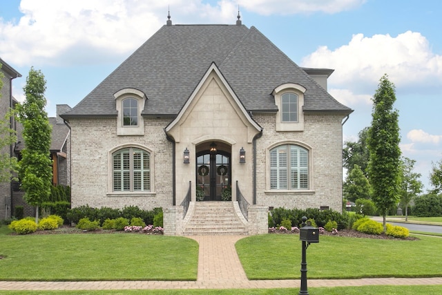 1141 Landing Pvt Ct, Gallatin, TN 37066 - french country style house with french doors, a front yard, roof with shingles, brick siding, and stone siding