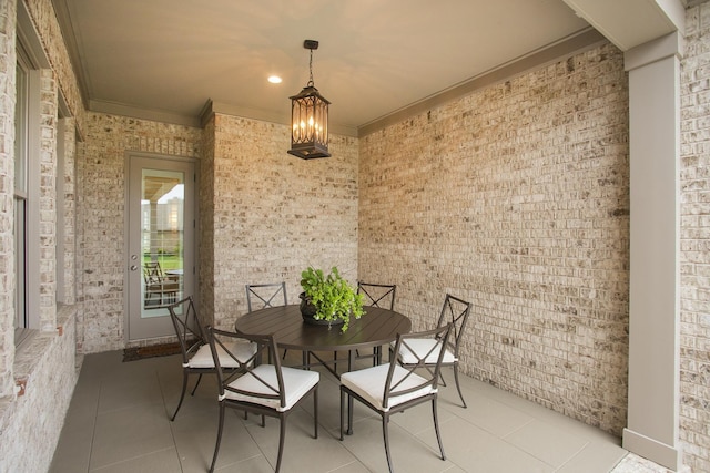 1141 Landing Pvt Ct, Gallatin, TN 37066 - dining area with crown molding, tile patterned floors, and brick wall