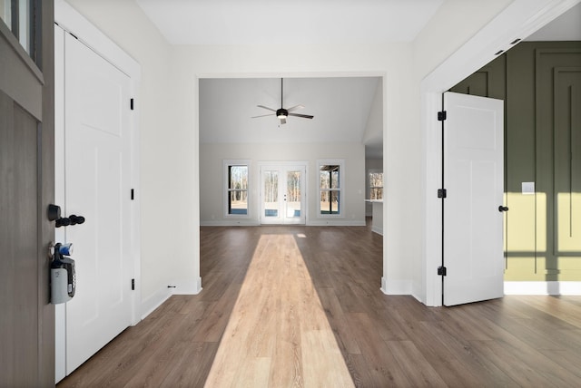 entrance foyer featuring hardwood / wood-style flooring, ceiling fan, and french doors