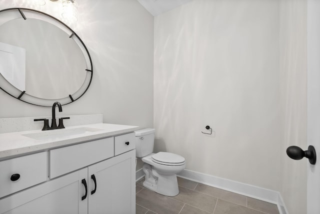 bathroom with tile patterned floors, vanity, and toilet