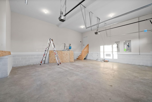 garage featuring electric panel and a garage door opener