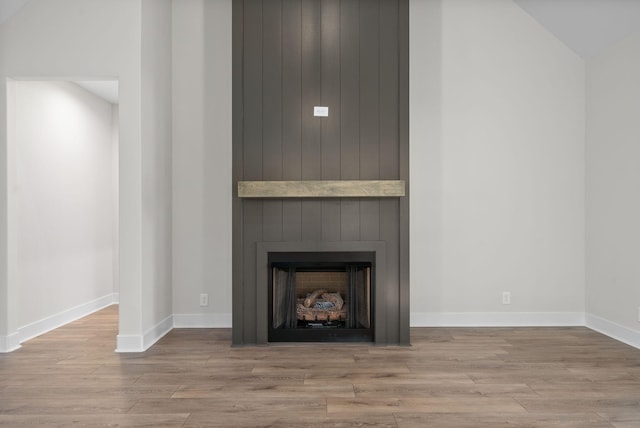 details featuring hardwood / wood-style floors and wood walls