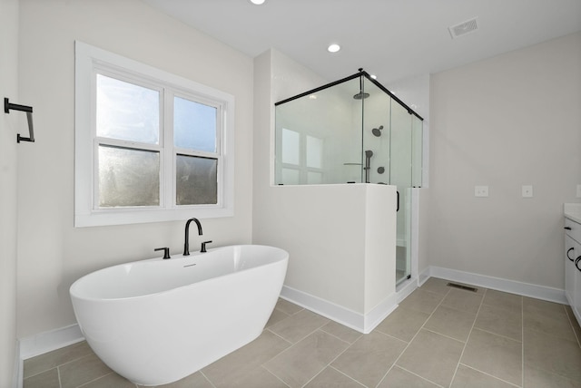 bathroom with plus walk in shower, vanity, and tile patterned floors