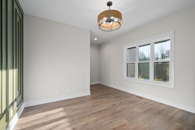 spare room featuring light hardwood / wood-style flooring