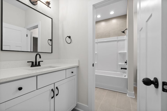 bathroom with vanity, tile patterned floors, and tiled shower / bath