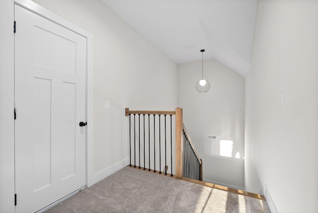 stairs featuring carpet and lofted ceiling