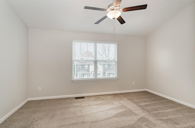 spare room with ceiling fan, carpet, and lofted ceiling