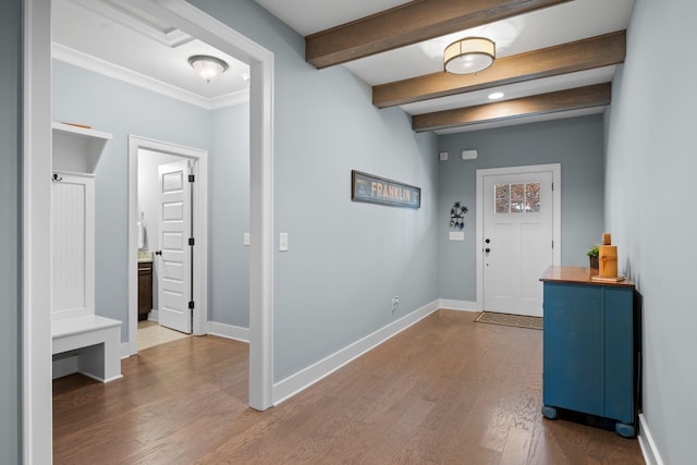 entryway with beam ceiling and hardwood / wood-style flooring