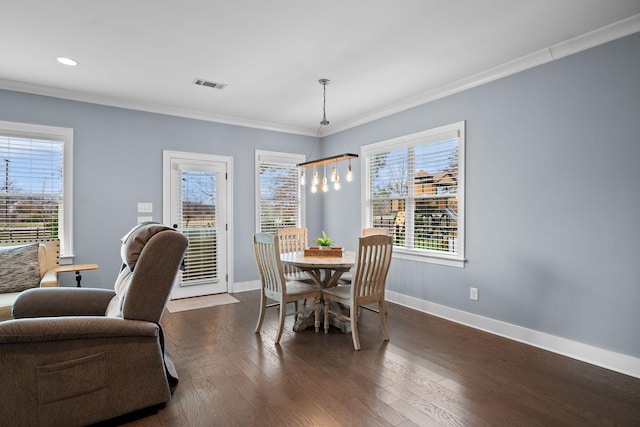 dining area featuring ornamental molding and dark wood-type flooring