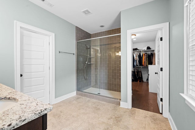 bathroom featuring hardwood / wood-style floors, vanity, and an enclosed shower