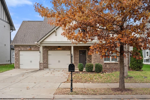 view of front of property featuring a garage, concrete driveway, roof with shingles, board and batten siding, and brick siding