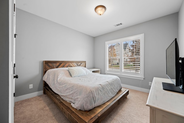 bedroom with light colored carpet