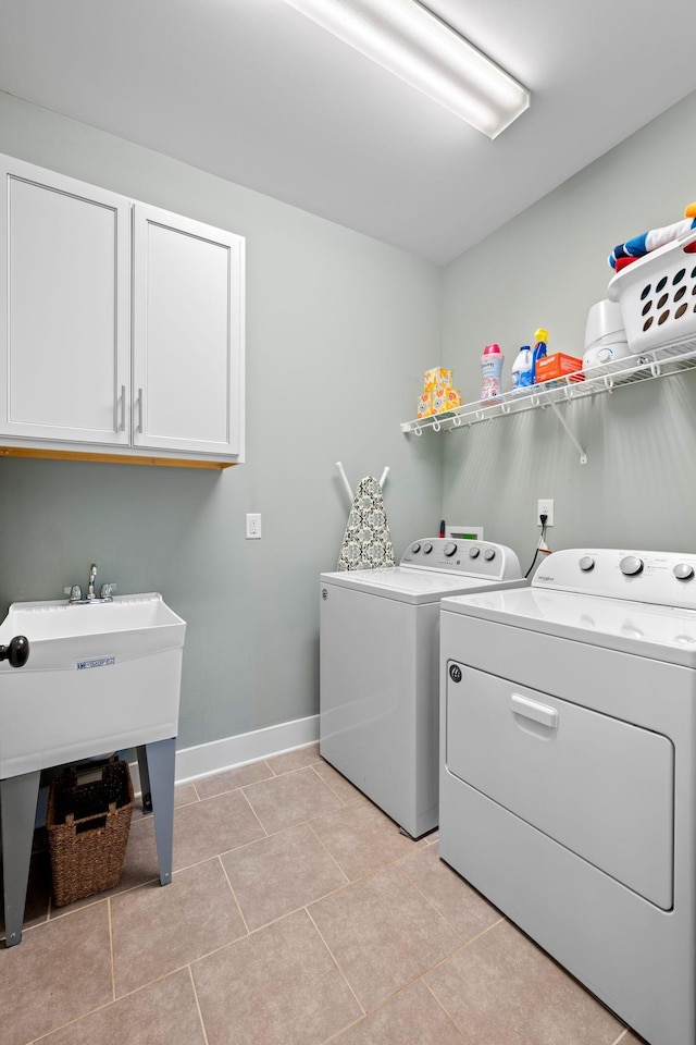 washroom featuring cabinets, light tile patterned floors, and separate washer and dryer