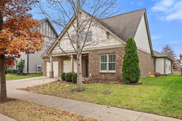 view of front facade with concrete driveway, brick siding, and a front lawn