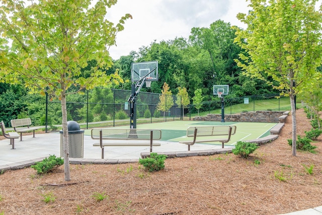 view of basketball court with a tennis court, community basketball court, and fence