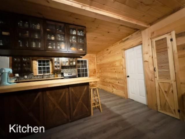 bar featuring hardwood / wood-style flooring, wooden ceiling, and wooden walls