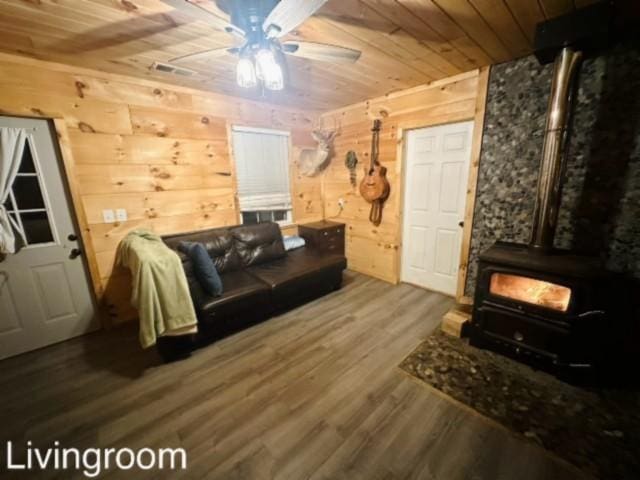 living room featuring hardwood / wood-style flooring, wooden walls, and wood ceiling