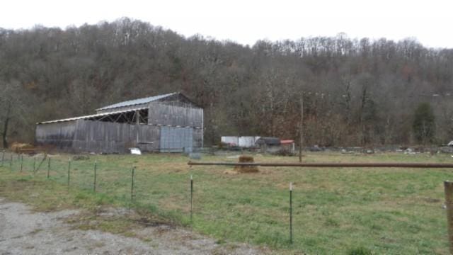 view of yard with a rural view and an outdoor structure