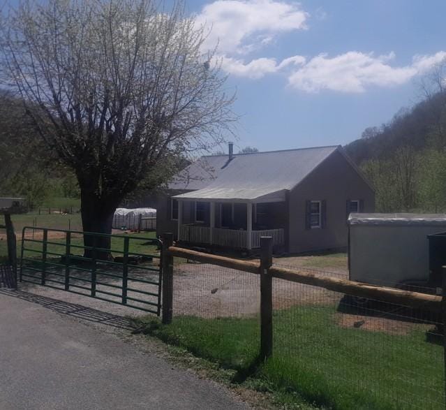 view of property exterior with a gate and a fenced front yard
