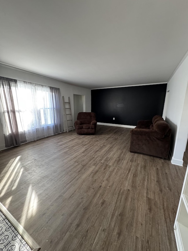 sitting room with wood-type flooring and crown molding