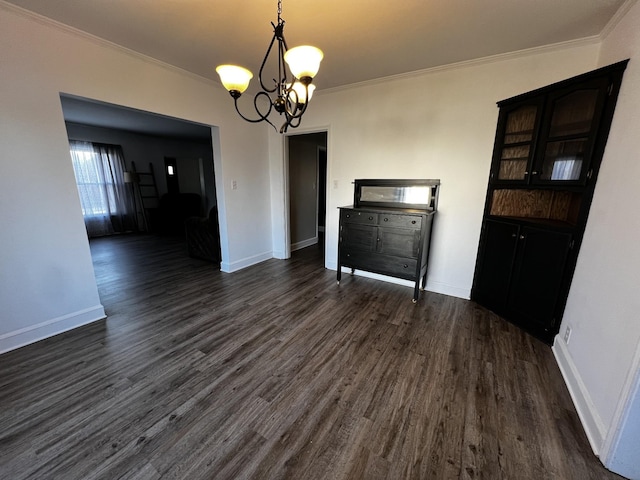 unfurnished dining area featuring ornamental molding, dark wood-type flooring, and a chandelier