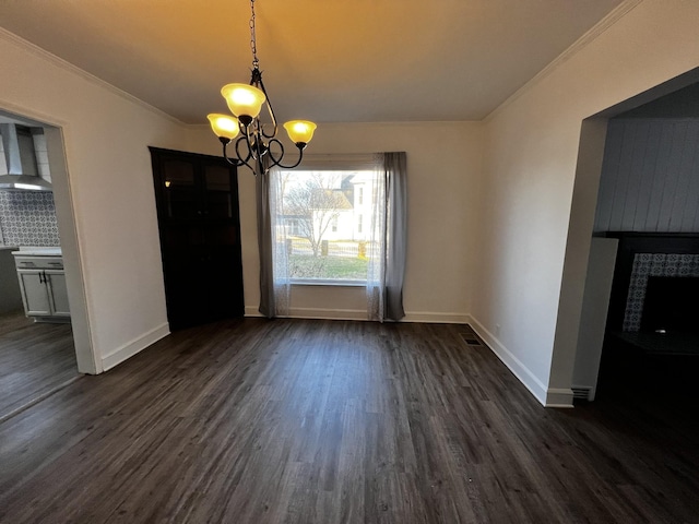 unfurnished dining area with ornamental molding, dark wood-type flooring, and a chandelier