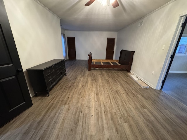 spare room featuring hardwood / wood-style floors, ceiling fan, and ornamental molding