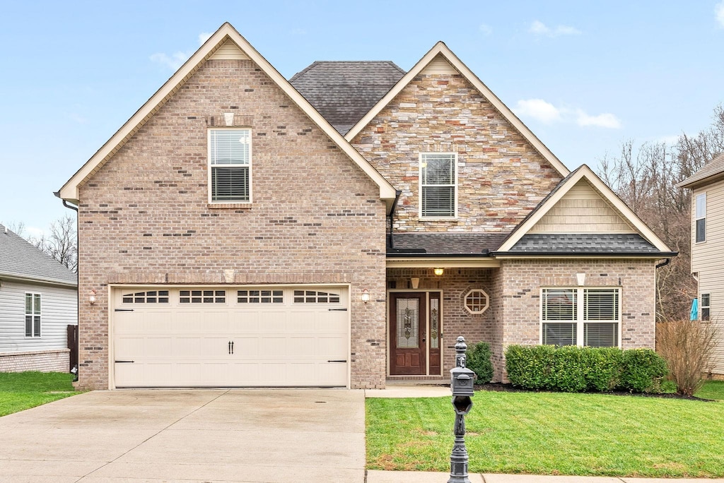 view of front of property with a garage and a front lawn