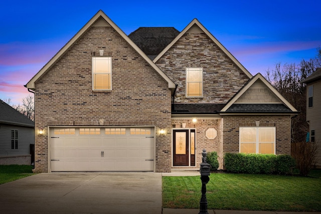 view of front facade with a yard and a garage