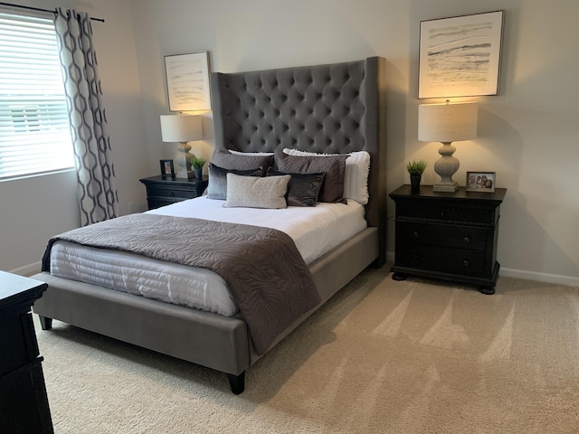 bedroom featuring light colored carpet