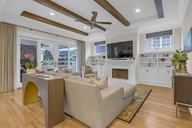 living room with french doors, light hardwood / wood-style floors, and a healthy amount of sunlight