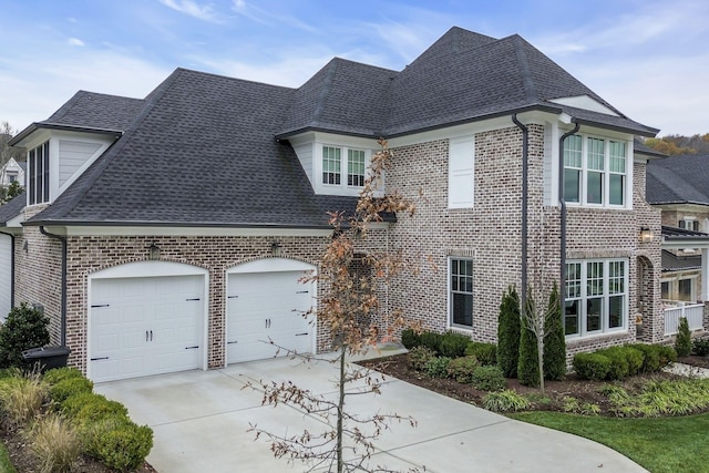 french country style house featuring a garage