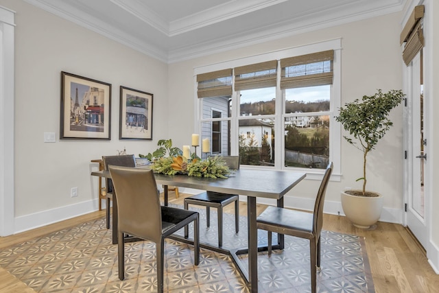 dining space featuring light wood-type flooring and ornamental molding