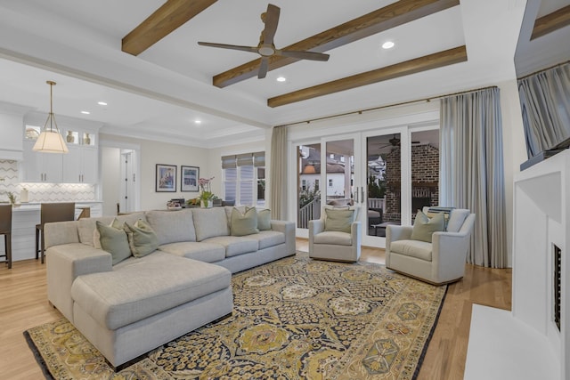 living room with beamed ceiling, ceiling fan, and light hardwood / wood-style floors