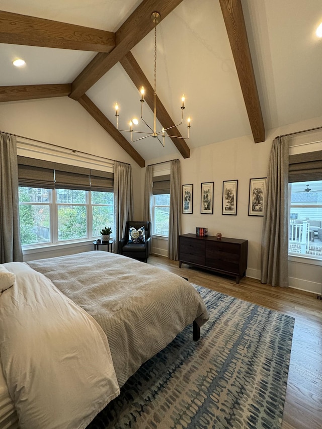 bedroom with lofted ceiling with beams, hardwood / wood-style flooring, and a notable chandelier