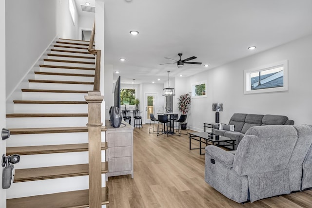 living room featuring ceiling fan and light hardwood / wood-style flooring