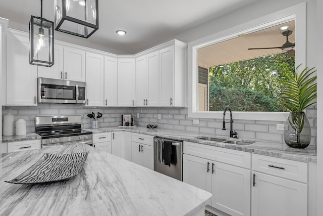 kitchen featuring white cabinetry, pendant lighting, stainless steel appliances, and sink