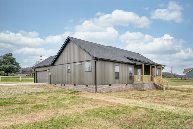 view of side of home with a garage and a lawn