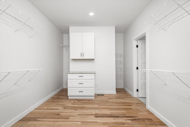 spacious closet featuring light hardwood / wood-style floors