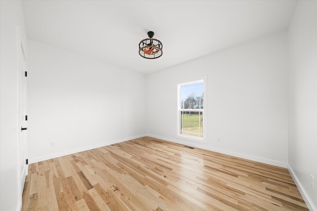 spare room with light hardwood / wood-style flooring