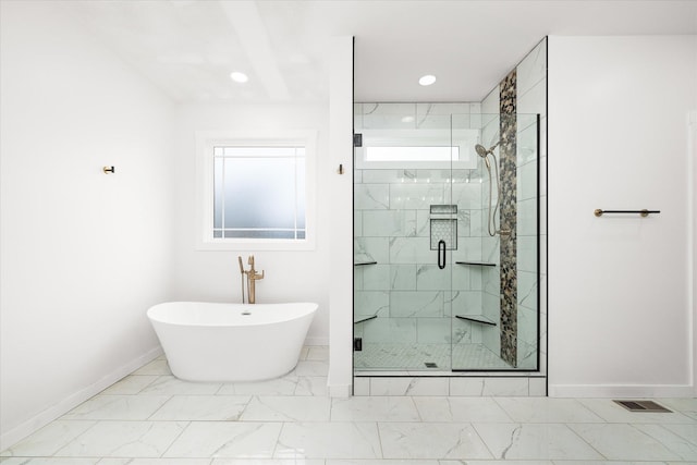 bathroom with separate shower and tub