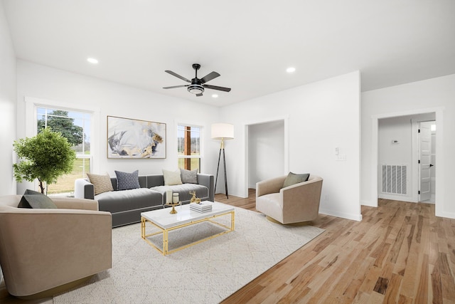 living room with ceiling fan and light wood-type flooring