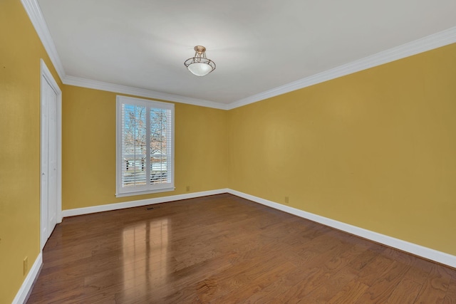 empty room with crown molding and hardwood / wood-style flooring