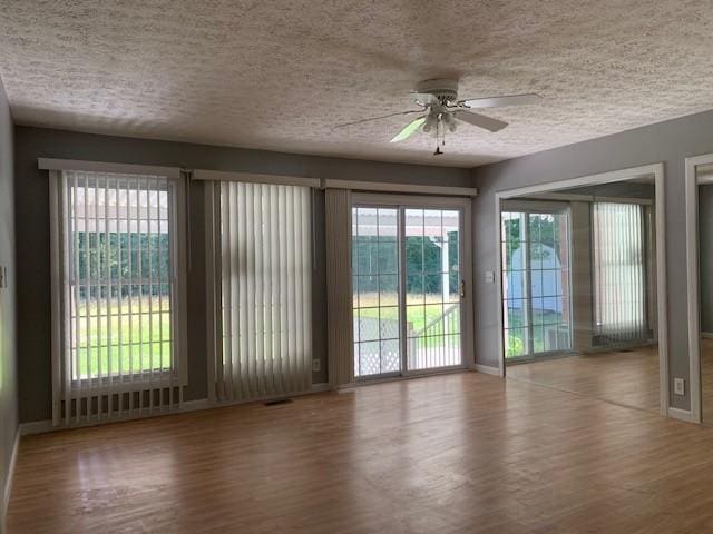 interior space with hardwood / wood-style floors, a textured ceiling, and ceiling fan