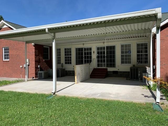 rear view of house featuring central AC unit