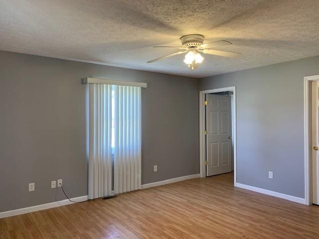 unfurnished room featuring ceiling fan, light hardwood / wood-style floors, and a textured ceiling