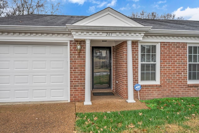 doorway to property with a garage