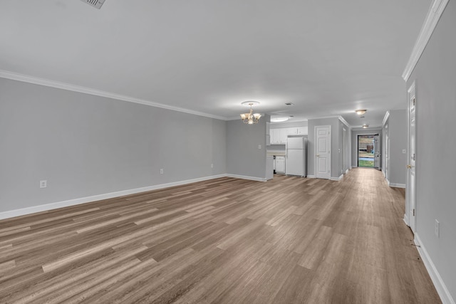 unfurnished living room with crown molding, a chandelier, and light wood-type flooring